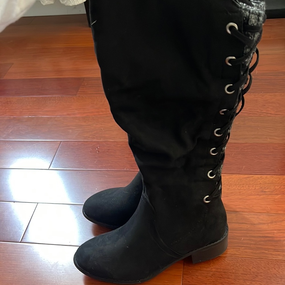 Woman’s tall black winter boot.